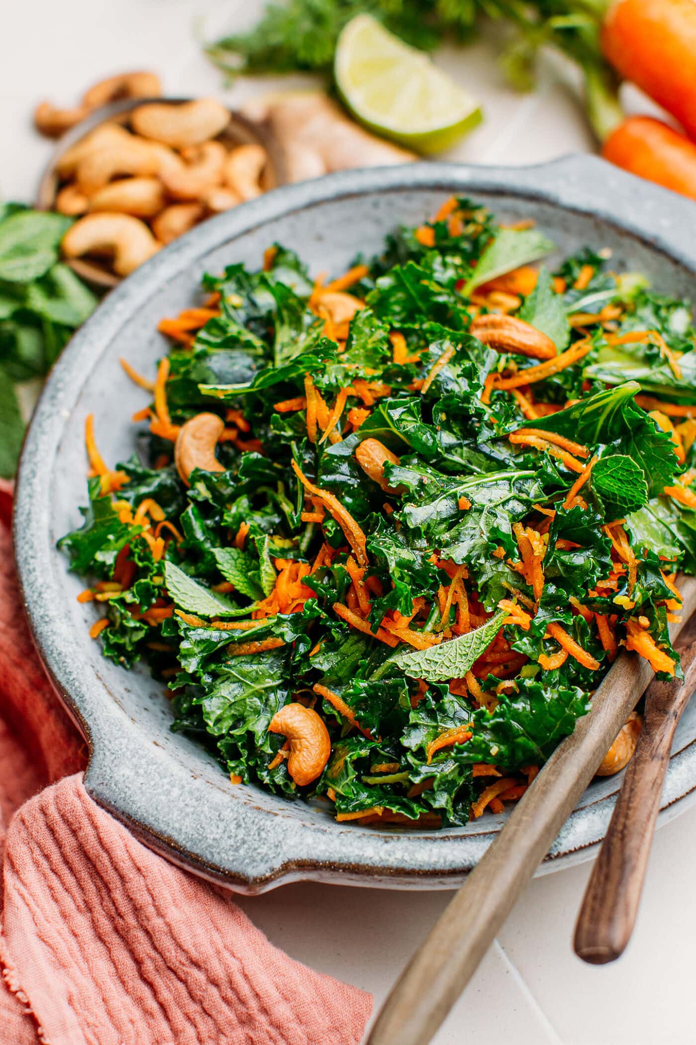 Close-up of kale and carrot salad with roasted cashews.