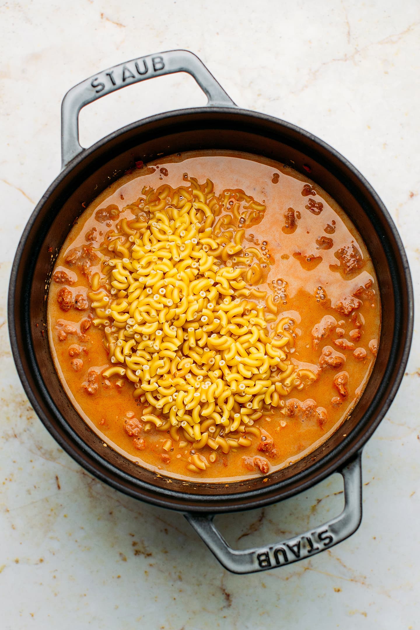 Dry macaroni and soy curls in a pot.