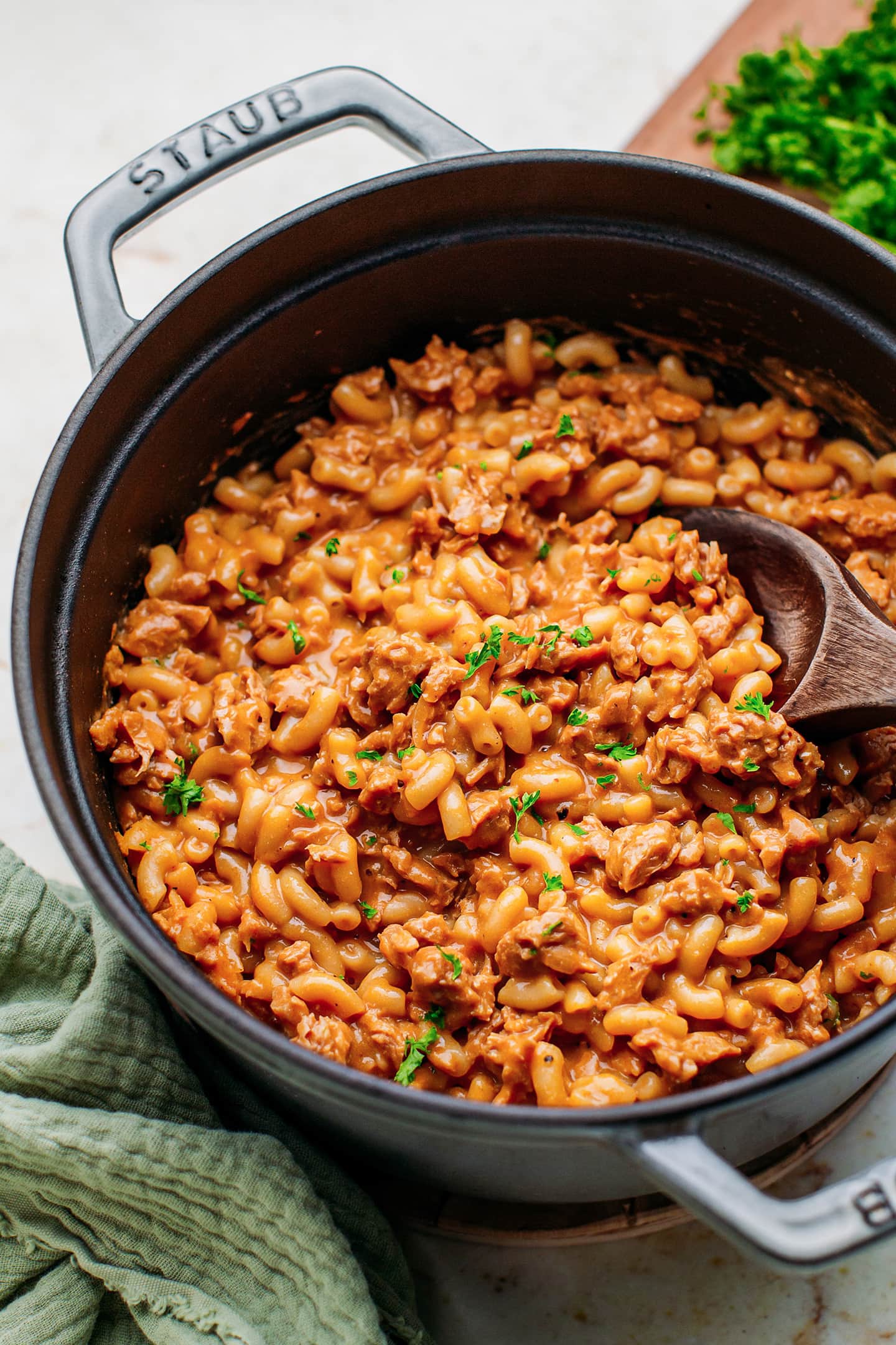 Hamburger helper in a Dutch oven topped with chopped parsley.