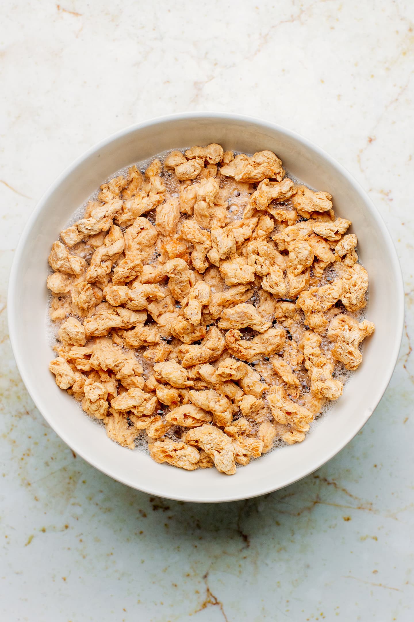 Soy curls rehydrating in water.