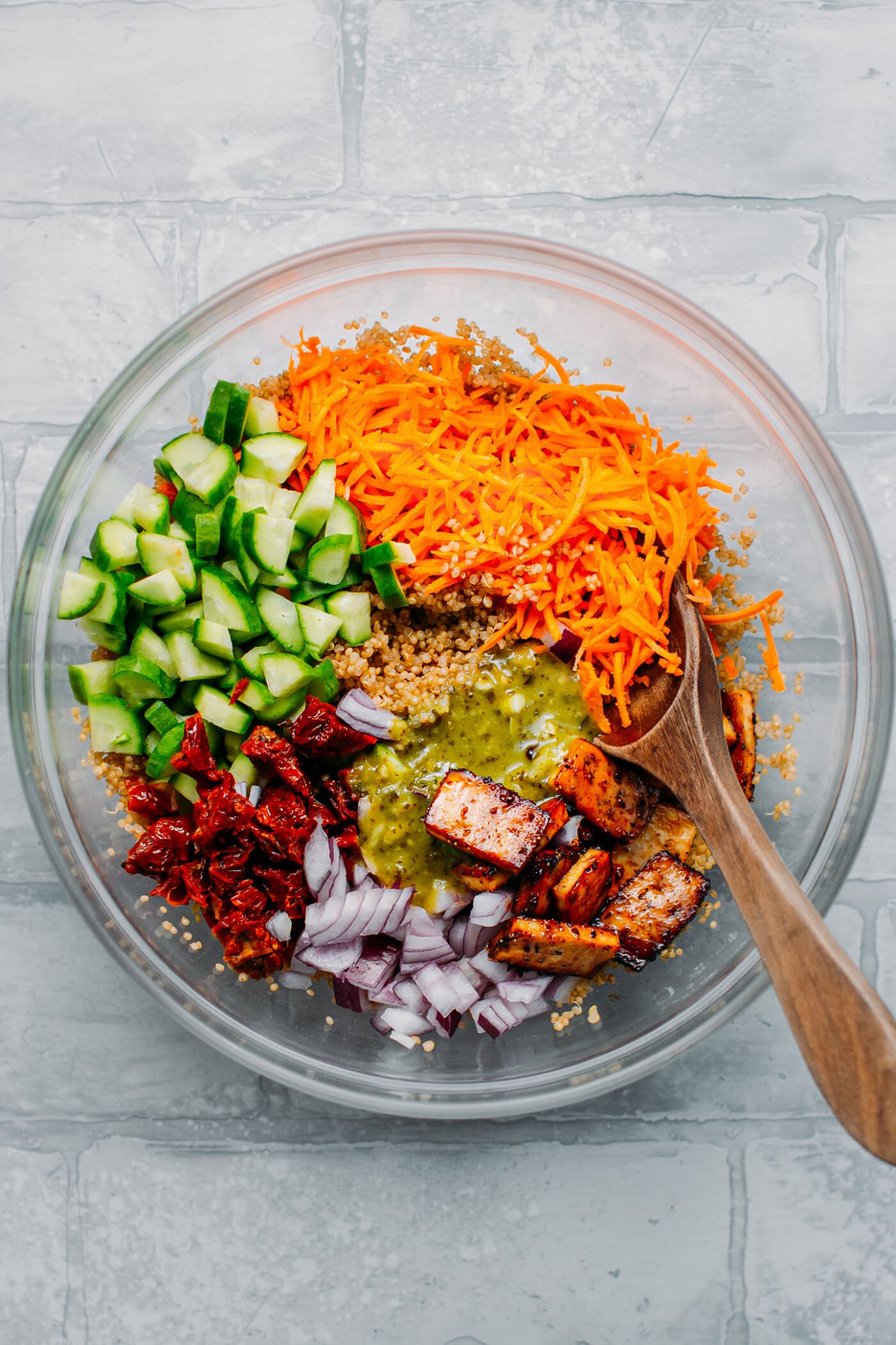 Cucumber, carrots, quinoa, tofu, and pesto to make salad.