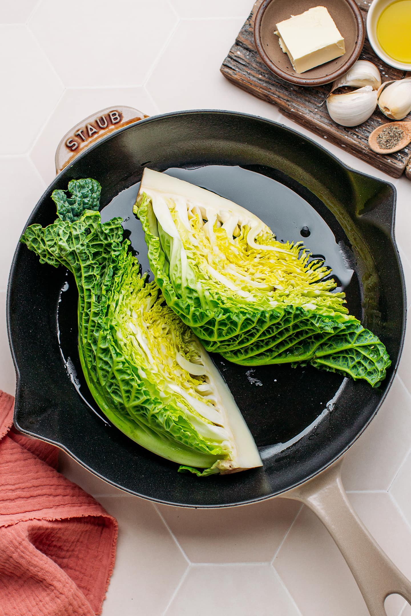 Quartered savoy cabbage in a skillet.