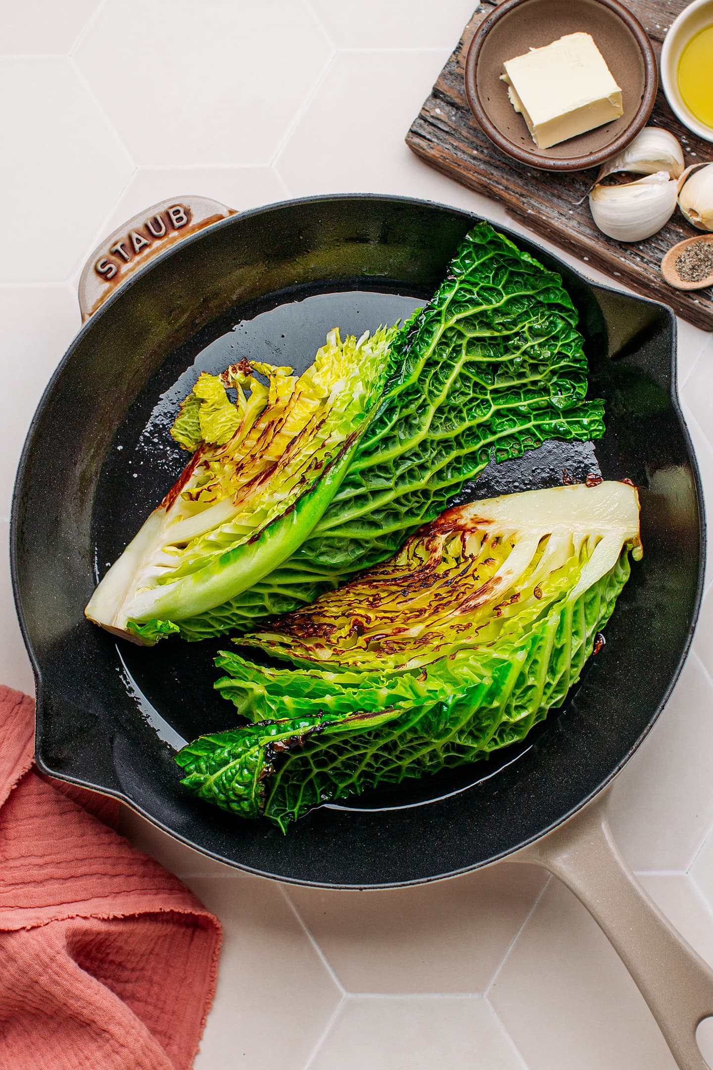 Braised savoy cabbage in a skillet.