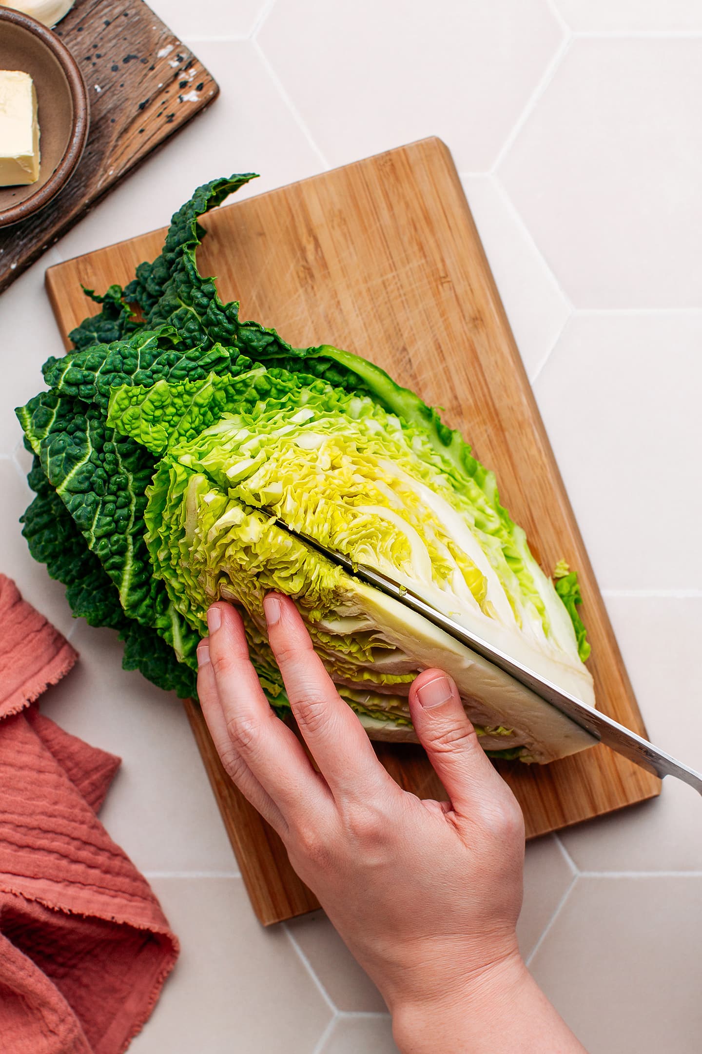 Slicing a quarter of a savoy cabbage head.