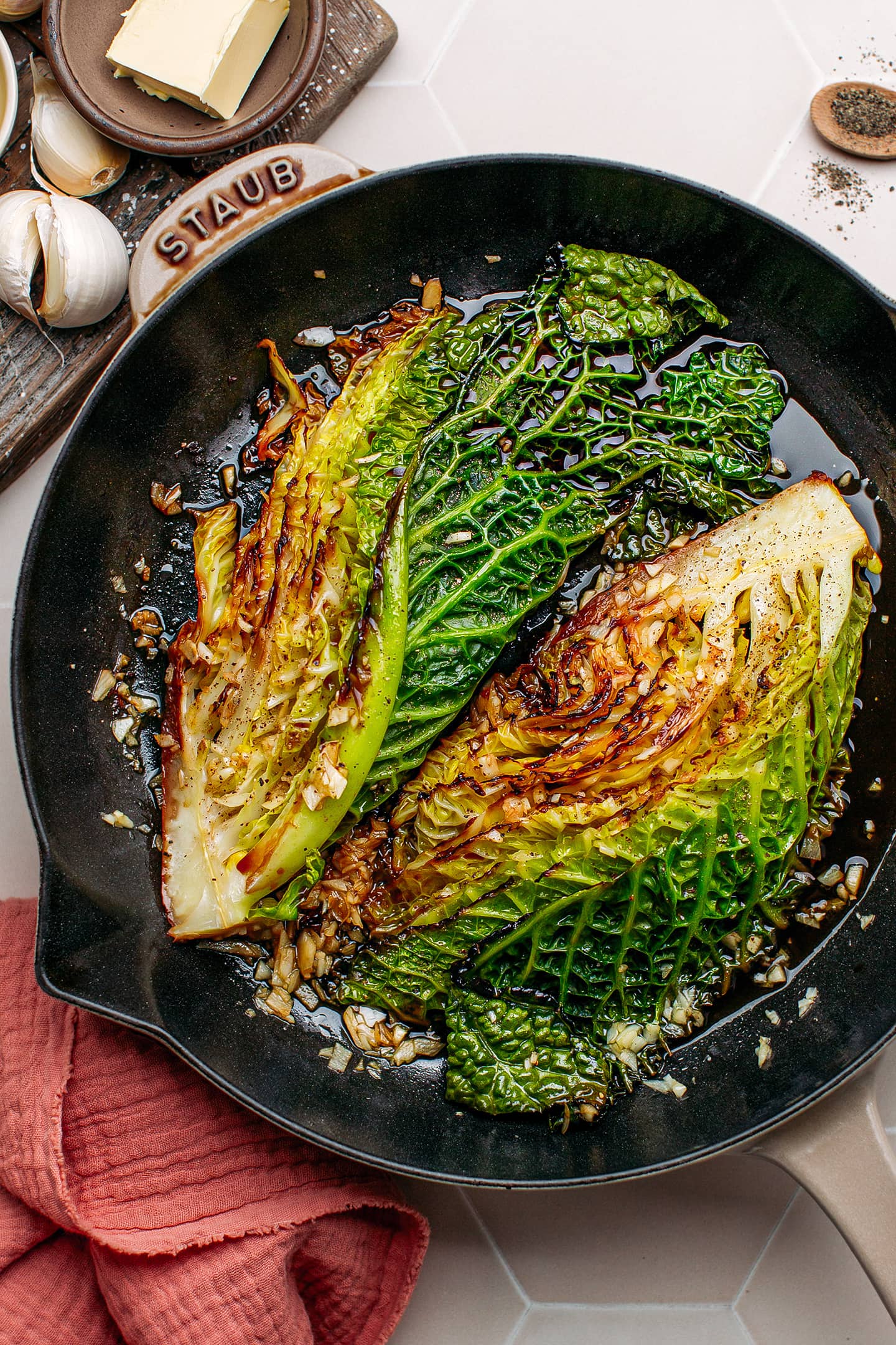 Braised cabbage with garlic in a skillet.