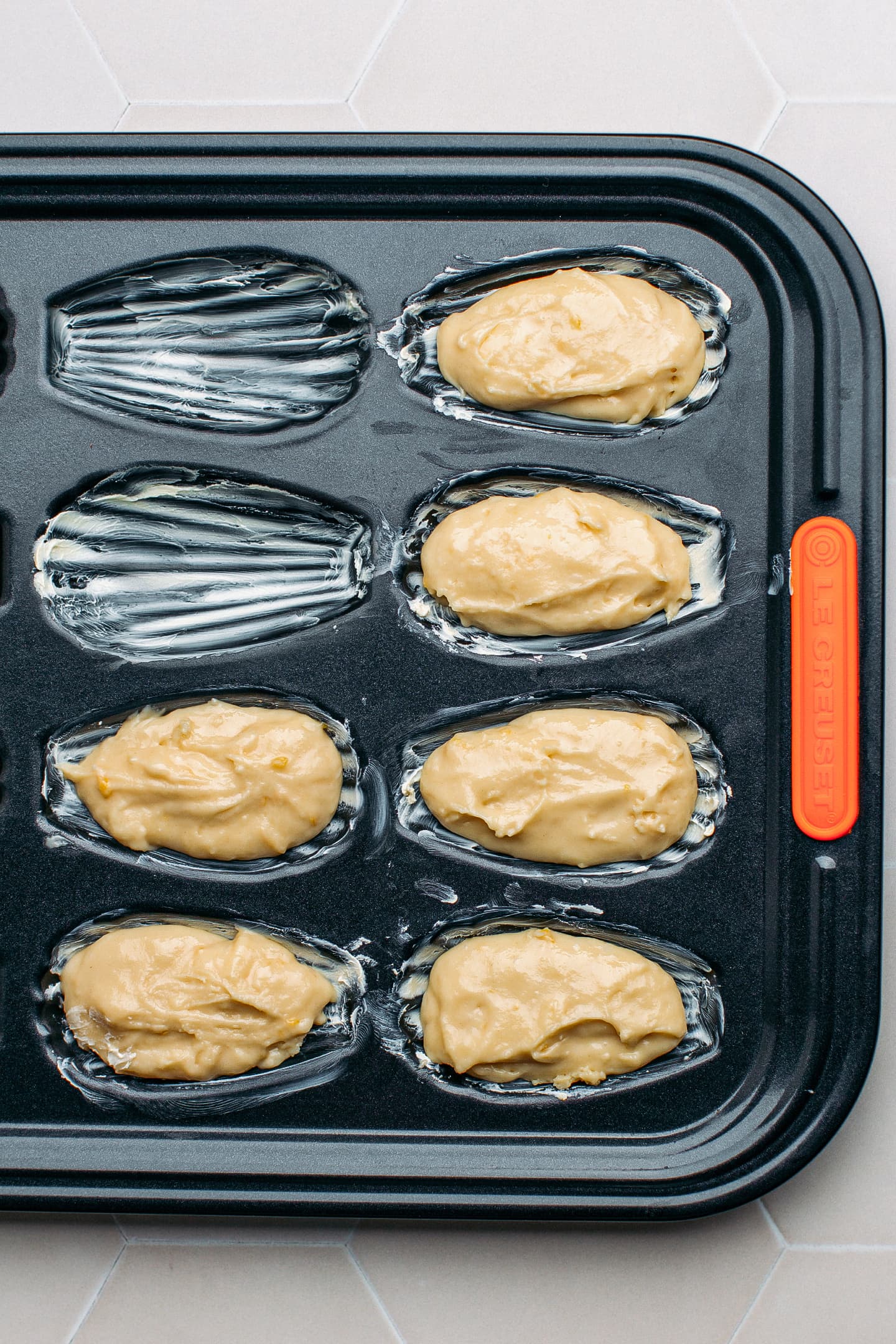 Madeleine batter in a pan.