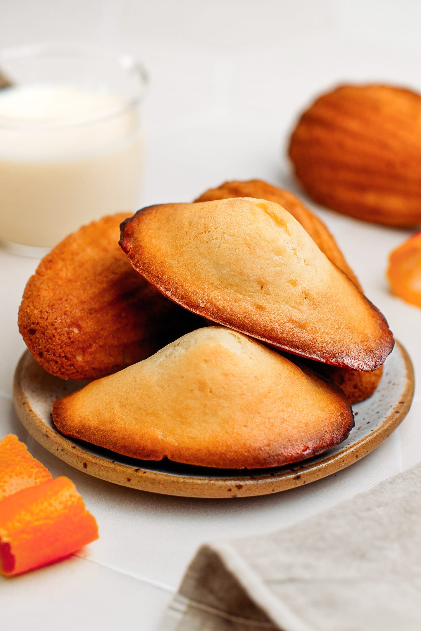 Vegan madeleines stacked on a small plate.