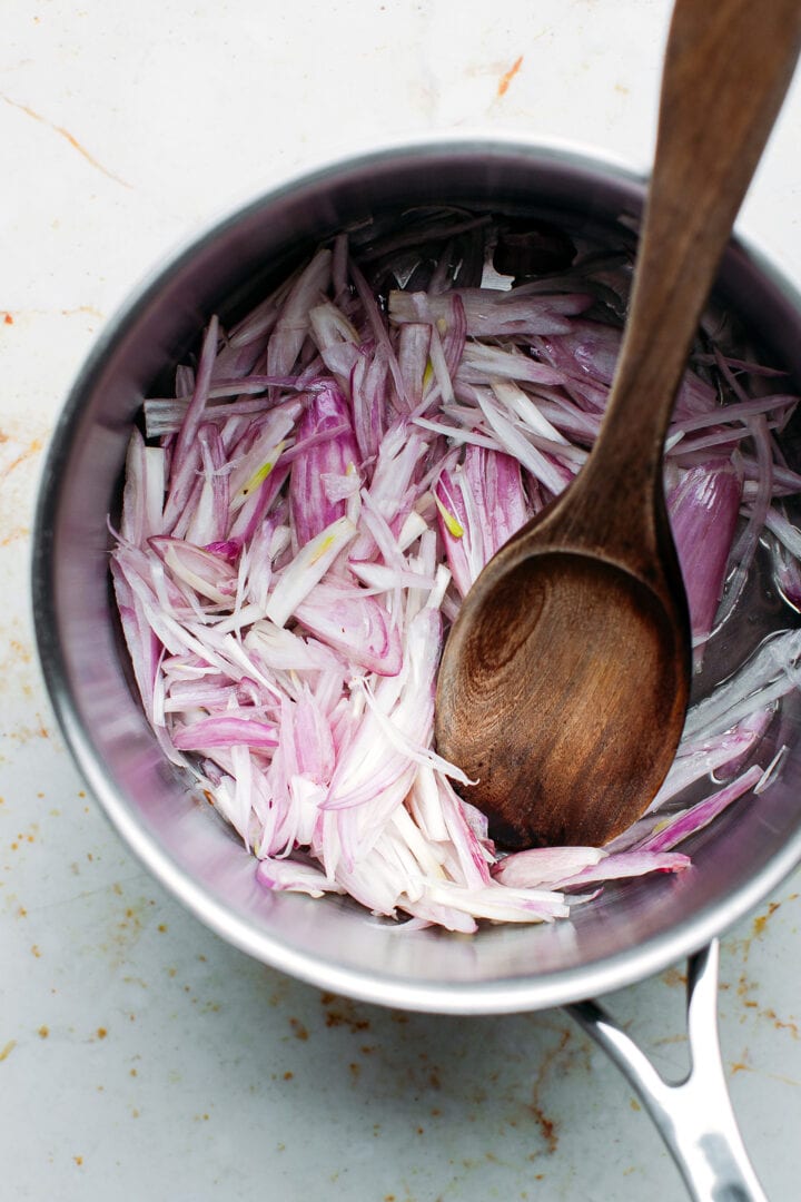 Sliced shallots in a saucepan.