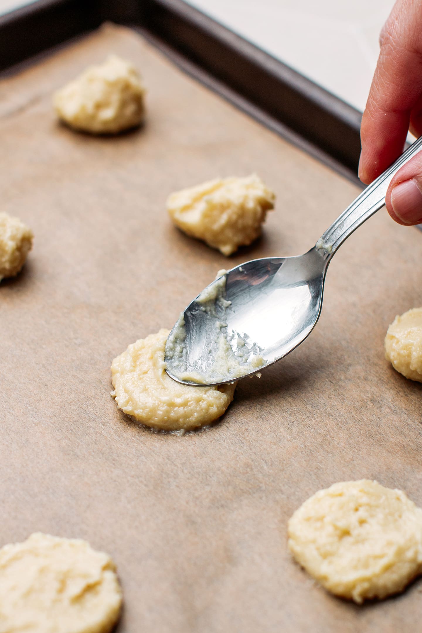 Spreading cookie batter on a baking sheet.