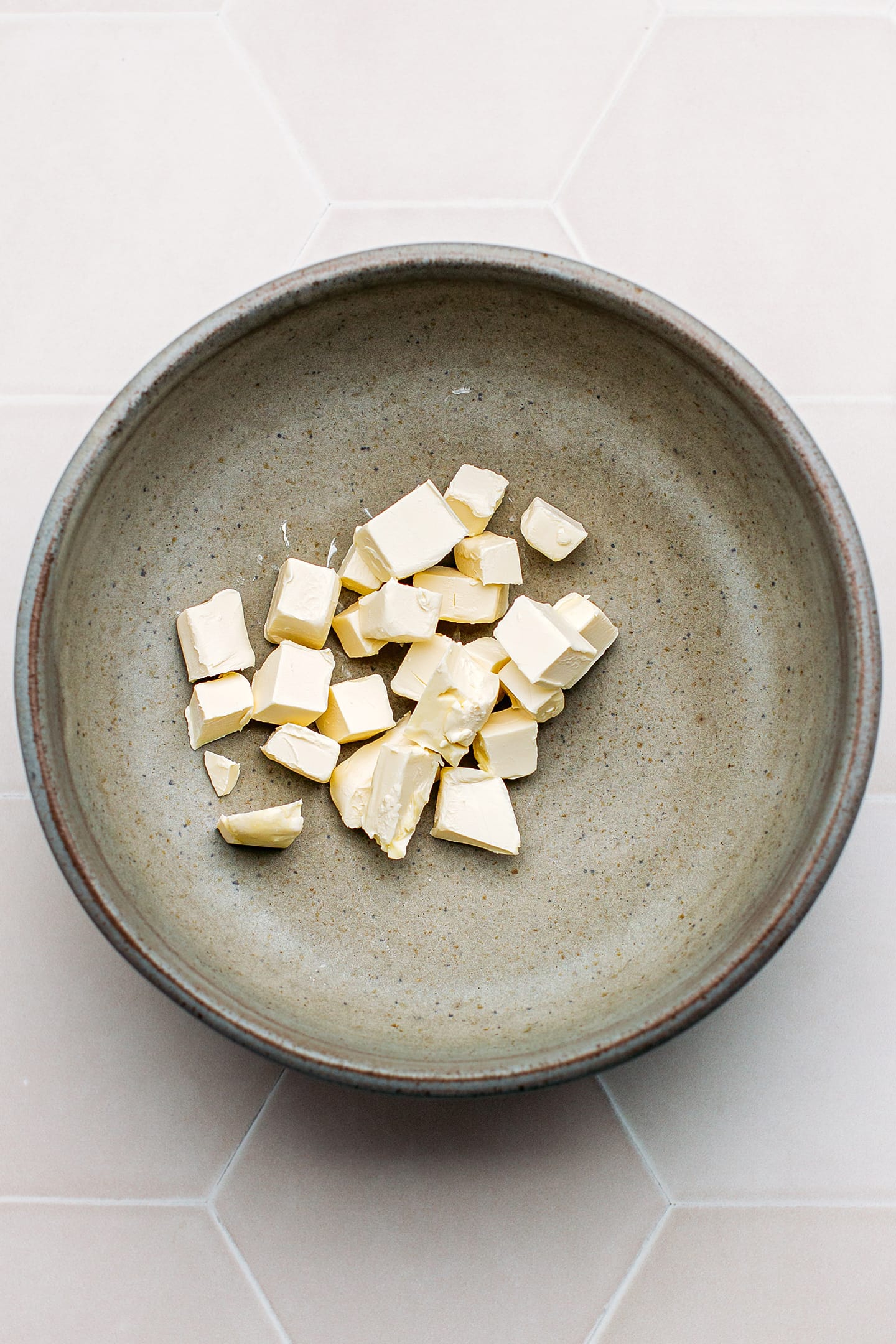 Diced butter in a mixing bowl.