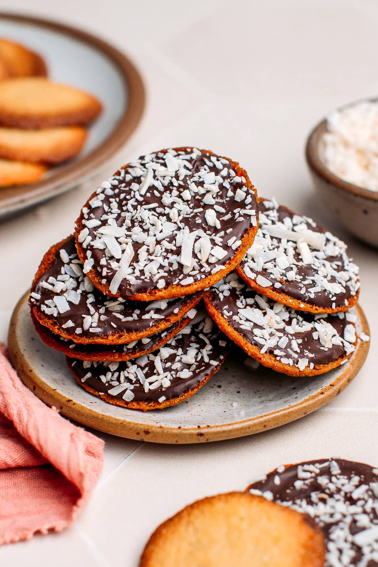 Stack of chocolate coconut cookies thins on a small plate.
