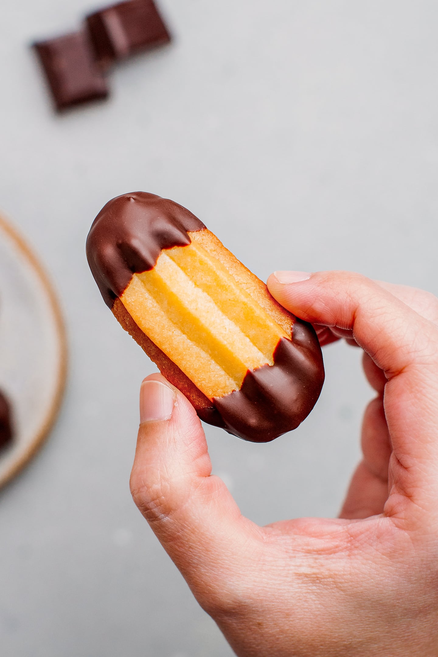 Holding a vegan spritz cookie.