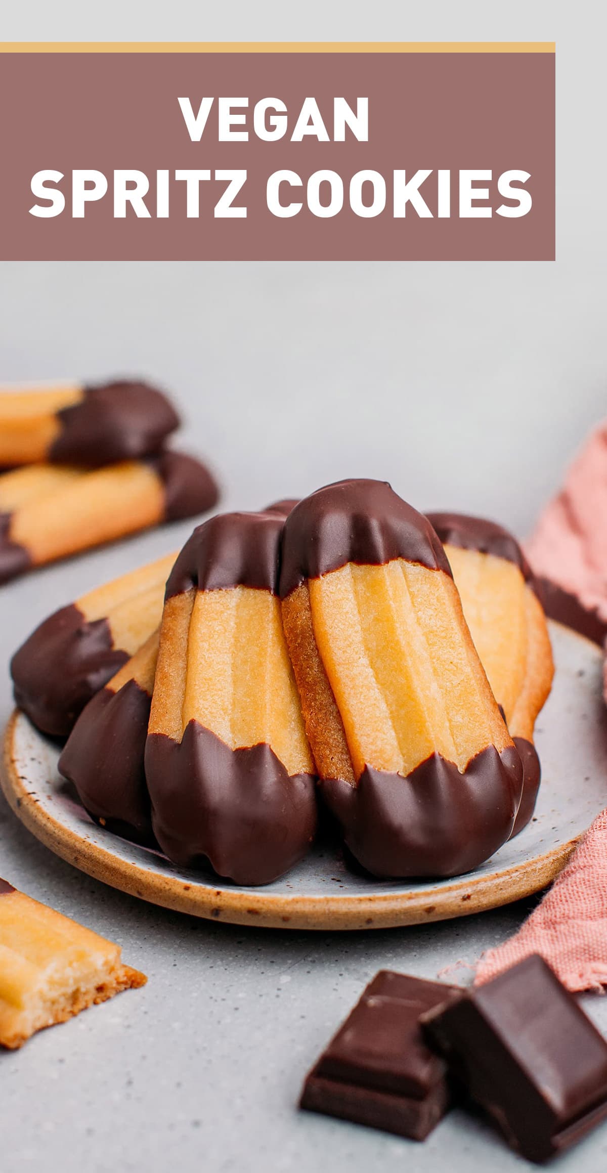 These German-inspired Spritz cookies are delightfully crispy, buttery, and dipped in dark chocolate. Whether you plan on devouring them or gifting them, these vegan cookies are a fun and easy treat that's perfect for the holidays! #holidays #veganbaking #cookies