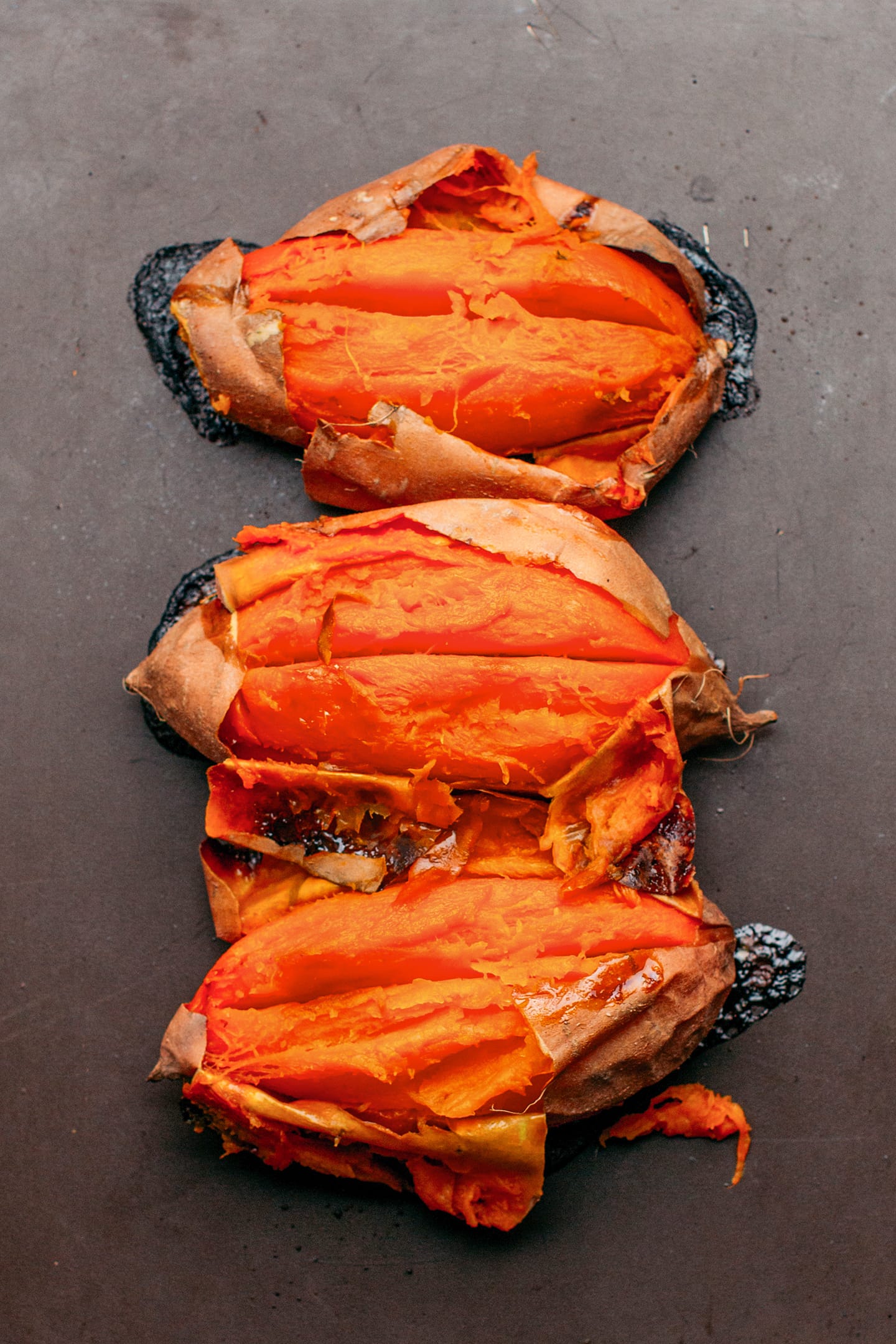 Baked sweet potatoes on a baking sheet.