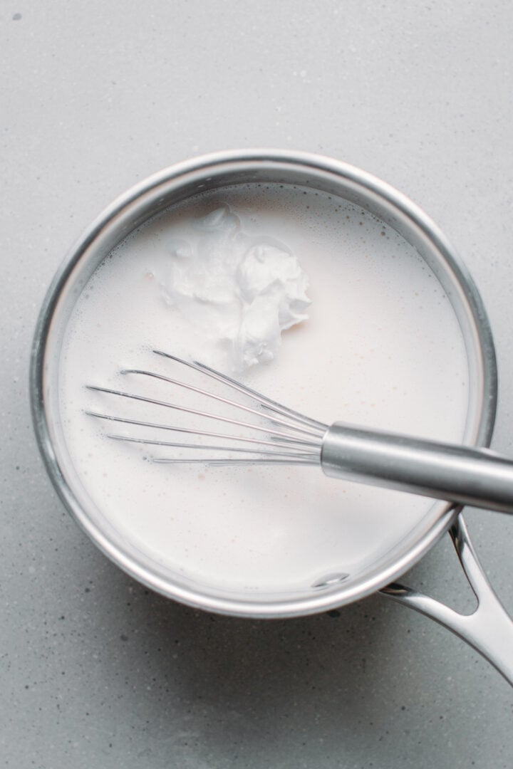 Almond milk and coconut cream in a saucepan.