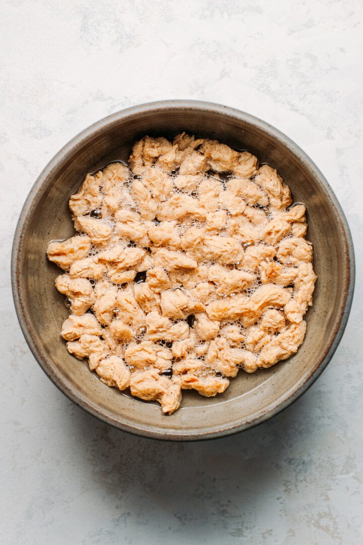 Soaking soy curls in warm water.