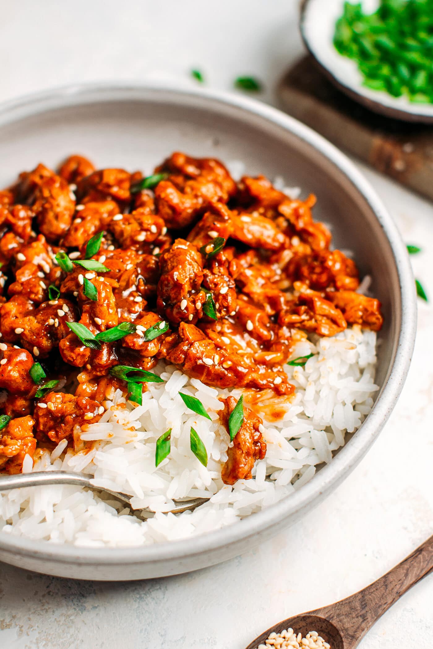 Close up of char siu soy curls with green onions.