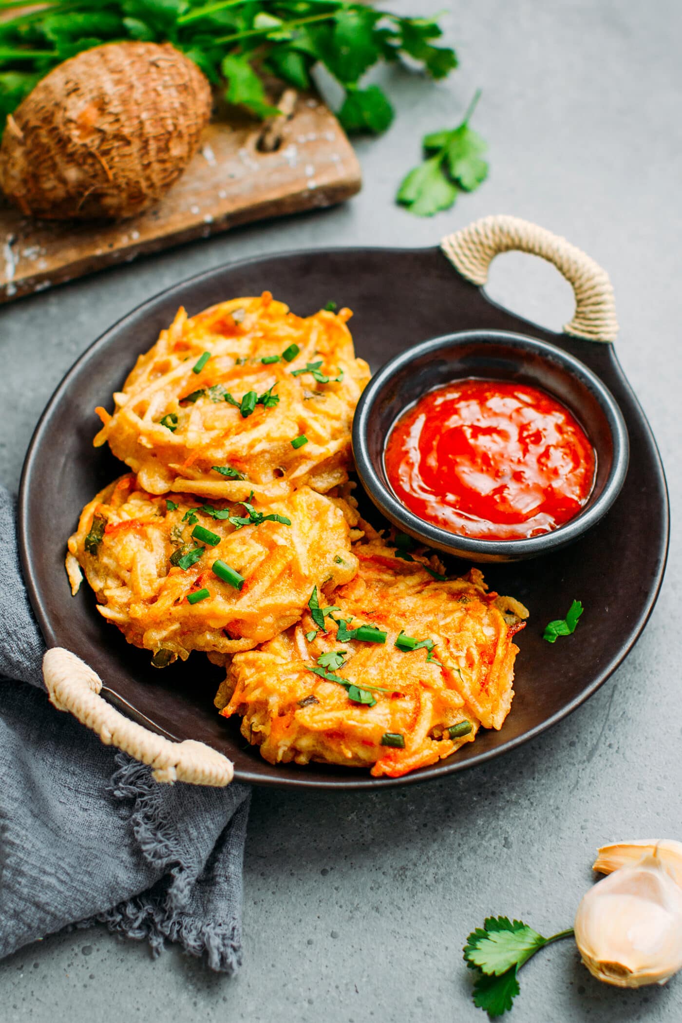 Fritters made with taro and carrots on a serving plate.