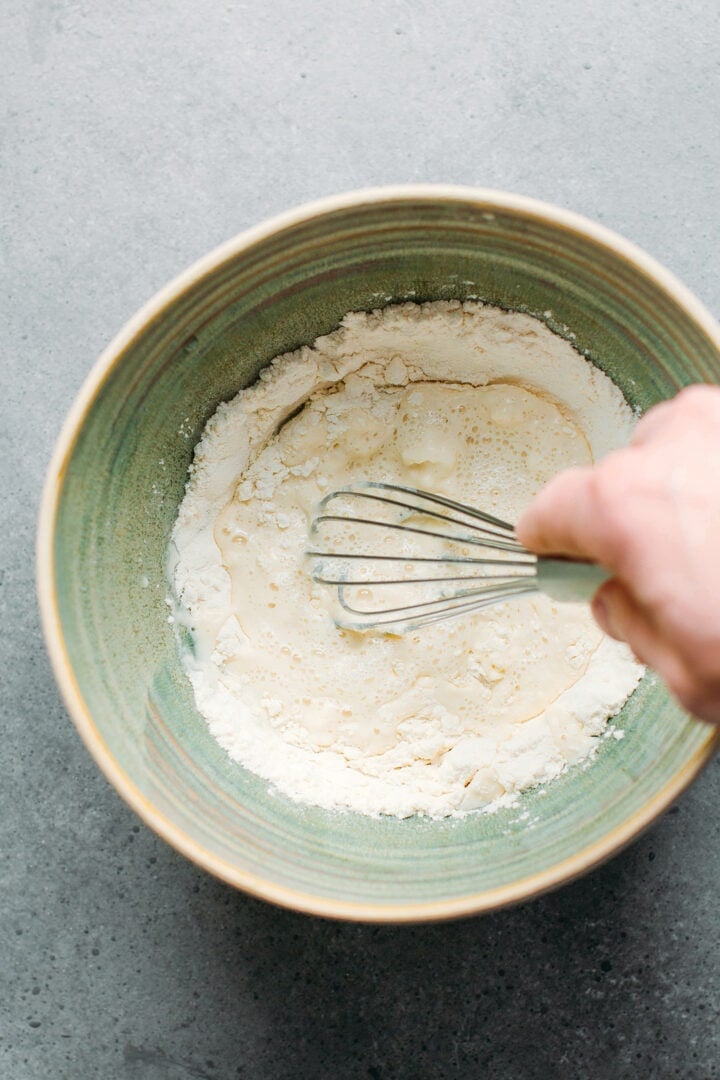 Whisking together flour with water.