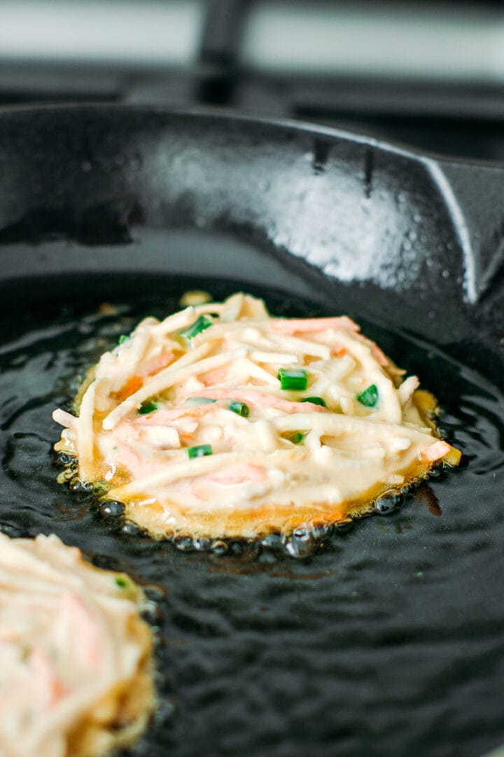 Frying taro fritters in oil.