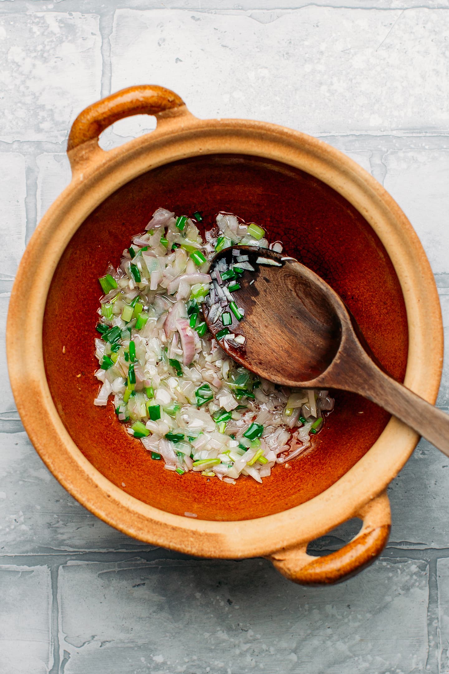 Sautéed shallots and garlic in a clay pot.