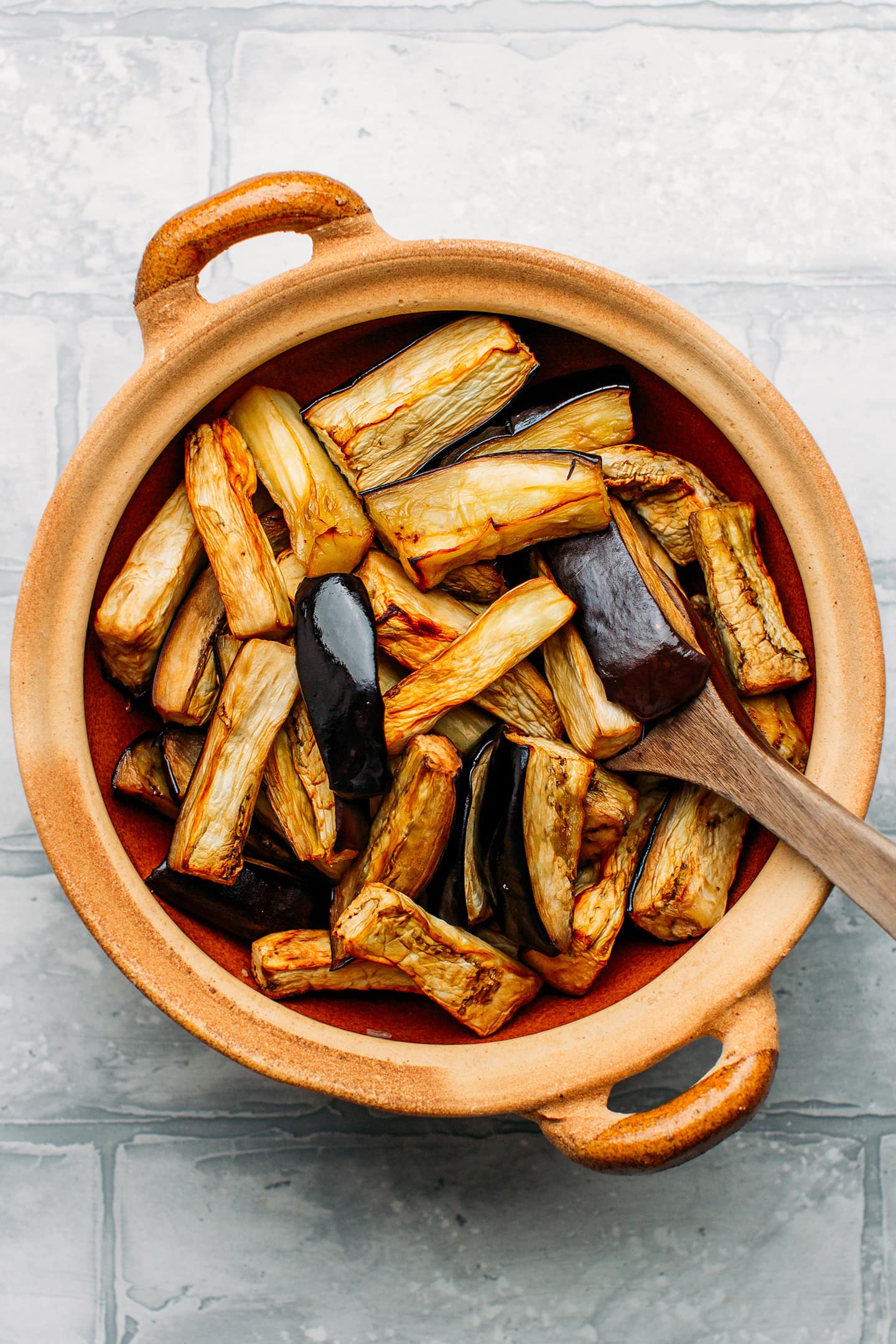 Roasted eggplants in a clay pot.