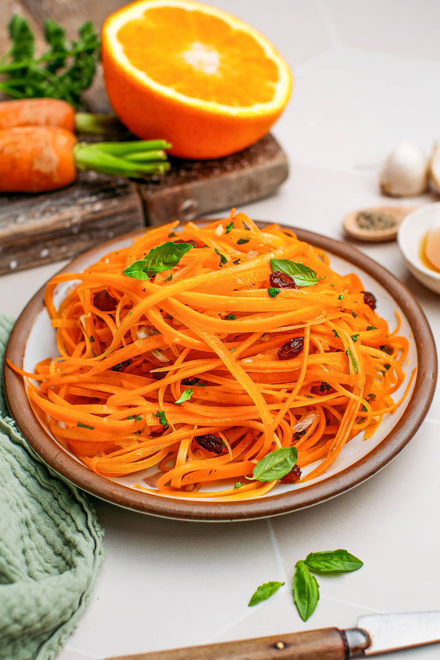 French carrot salad with basil and raisins on a plate.