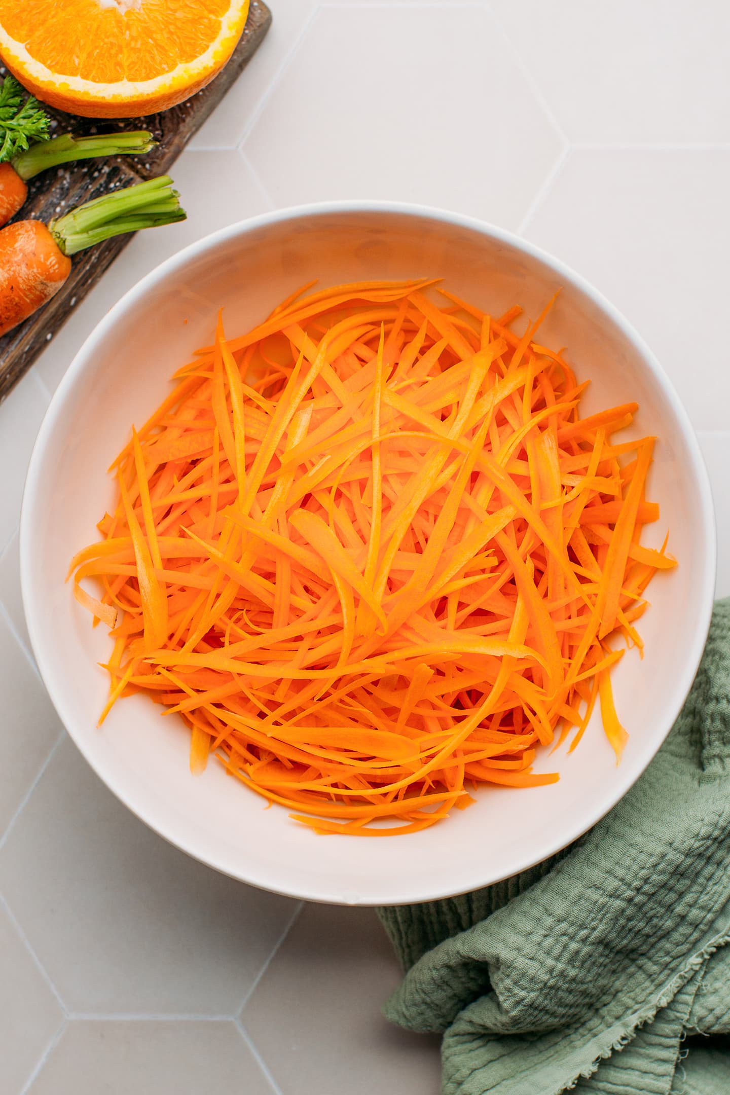 Grated carrots in a mixing bowl.