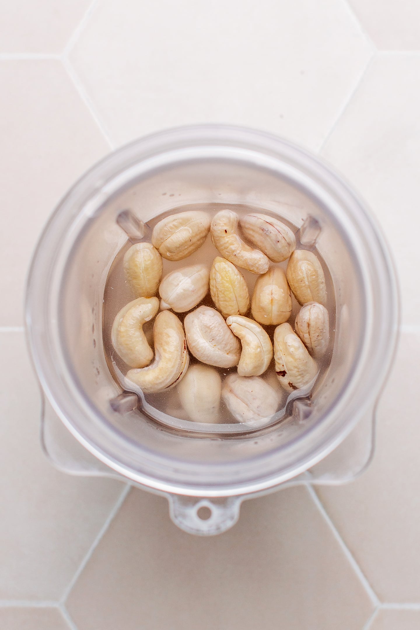 Cashews and water in a blender bowl.