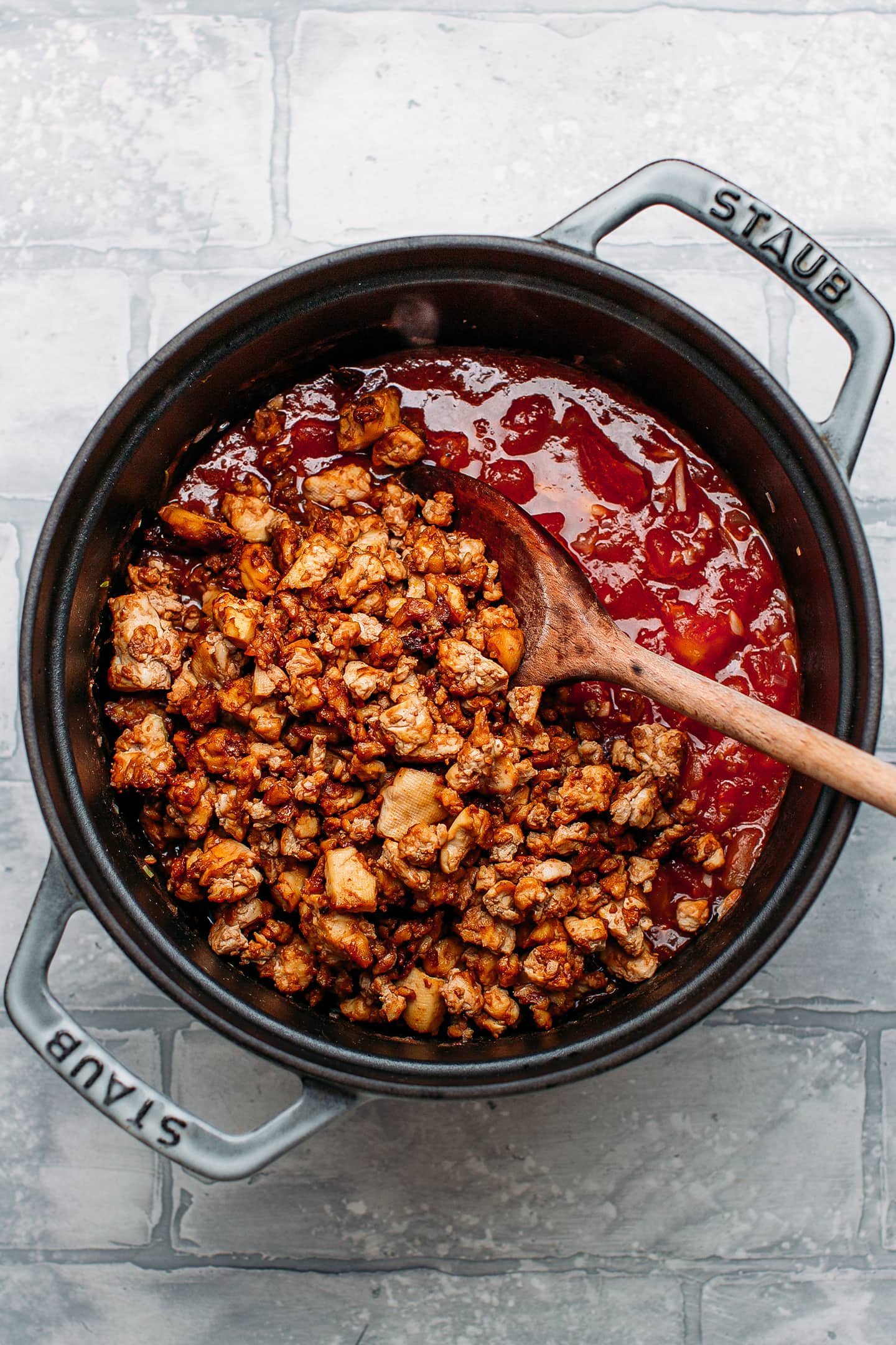 Diced tomatoes and tofu in a pot.