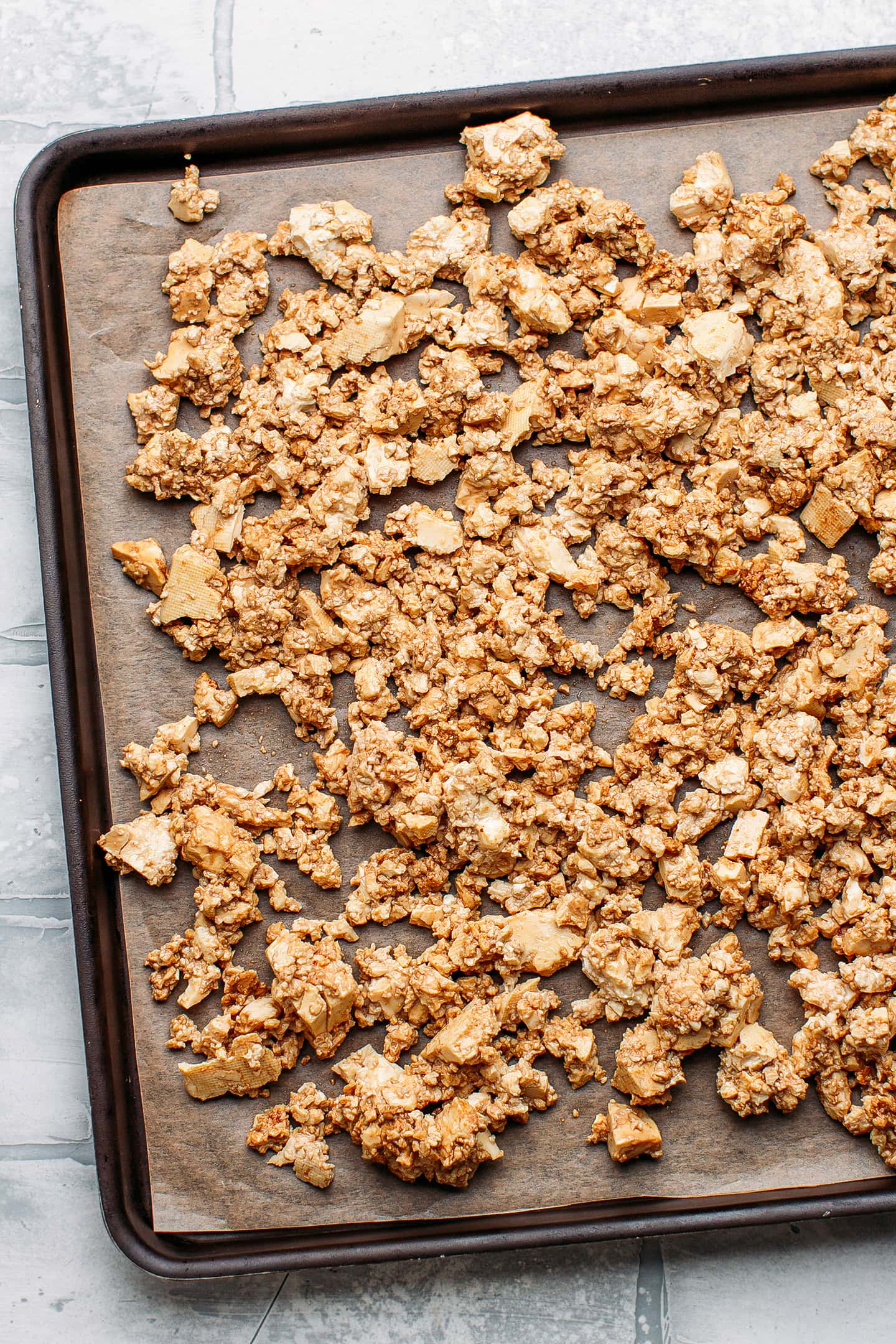 Crumbled tofu on a baking sheet.