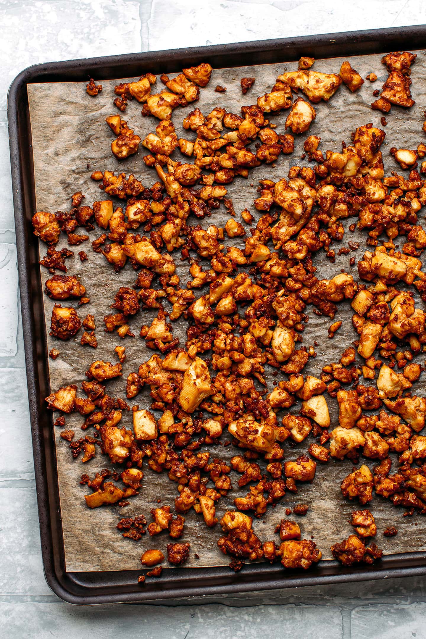 Baked crumbled tofu on a baking sheet.