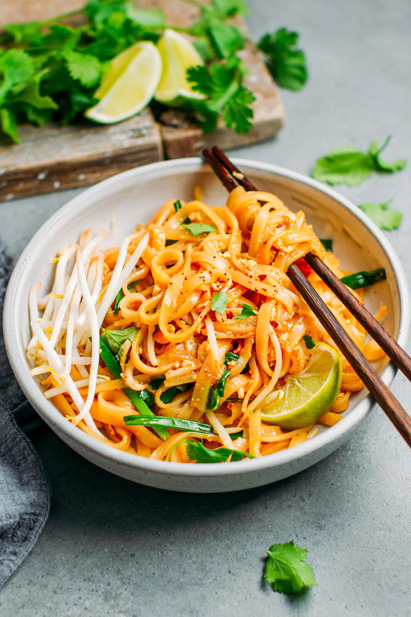 Vegetarian pad thai in a bowl with chopsticks.