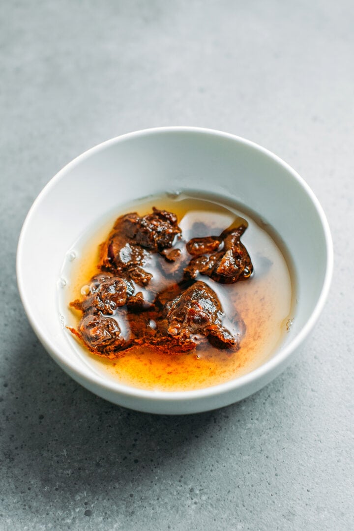 Tamarind pulp with water in a bowl.