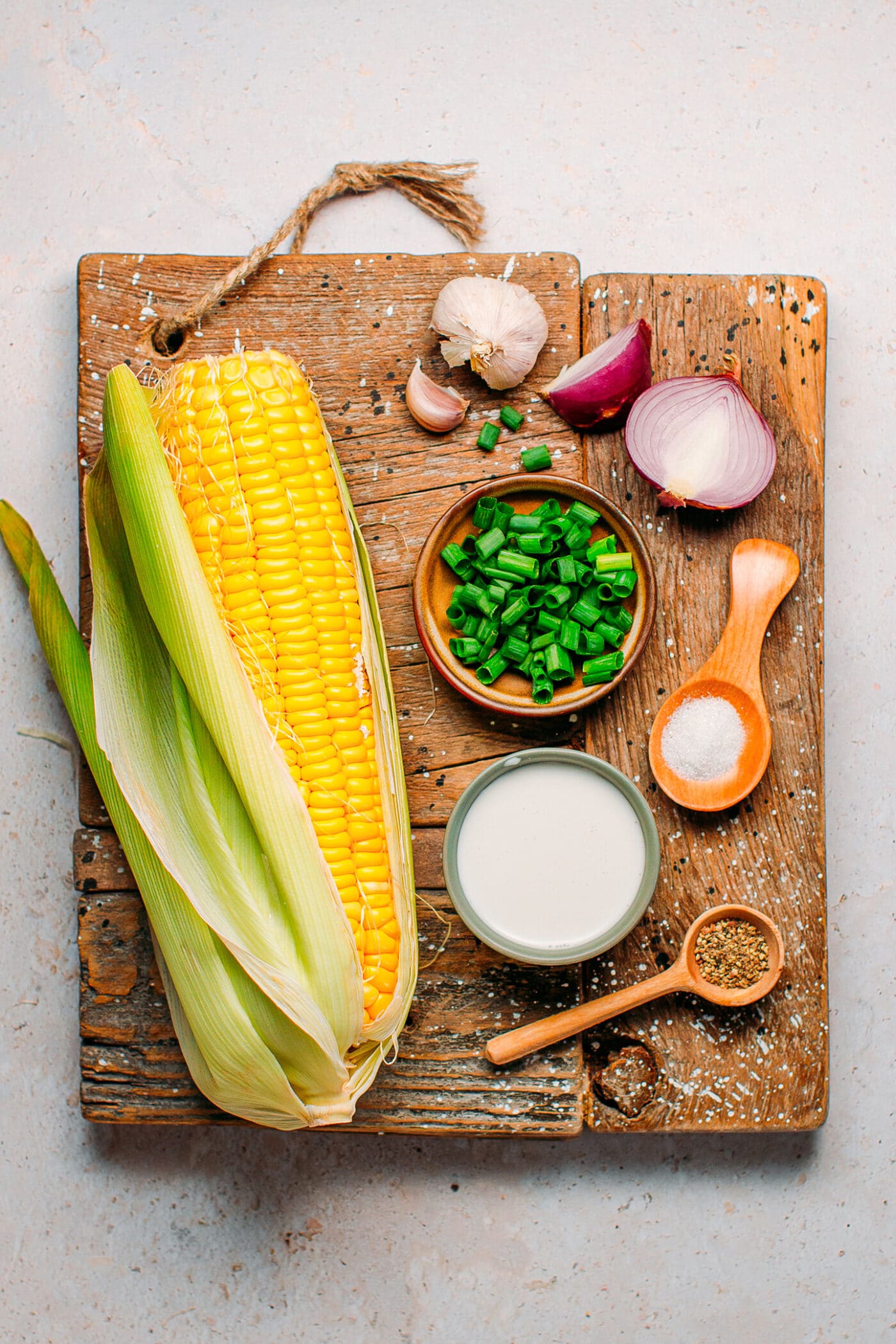 Ingredients like corn, shallots, garlic, black pepper, and coconut cream.