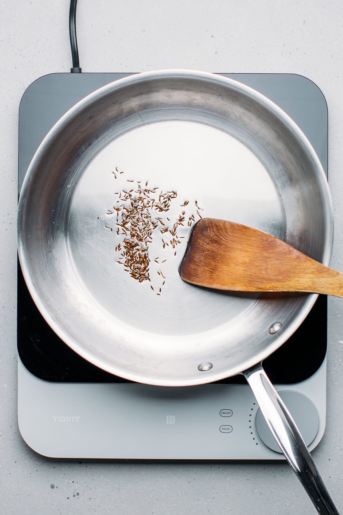 Sautéed cumin seeds in a pan.