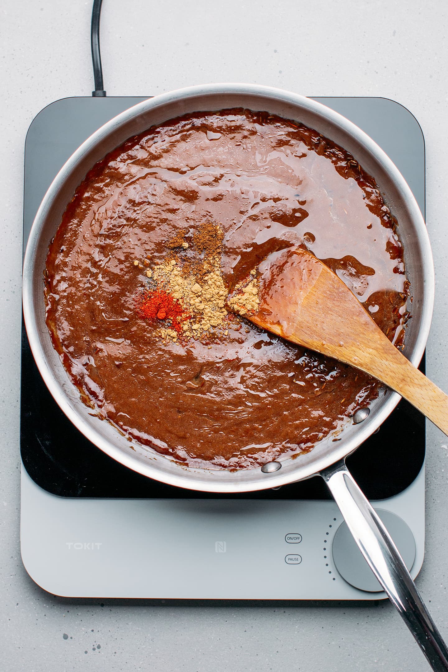 Tamarind sauce and spices in a skillet.