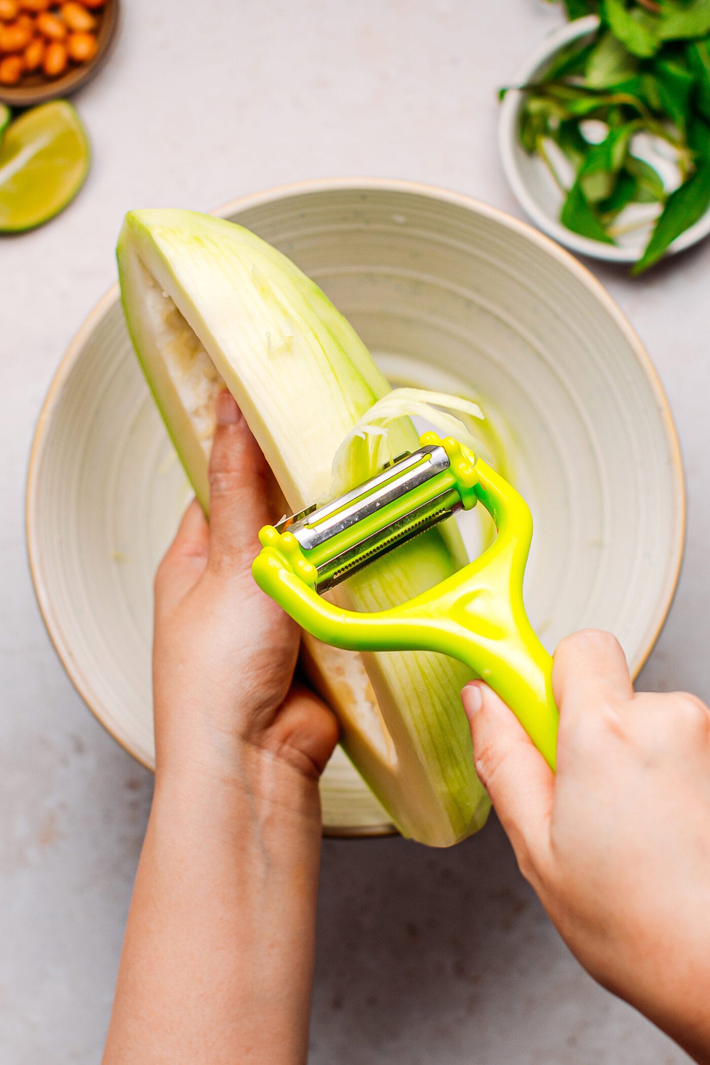 Grating green papaya using a grater.