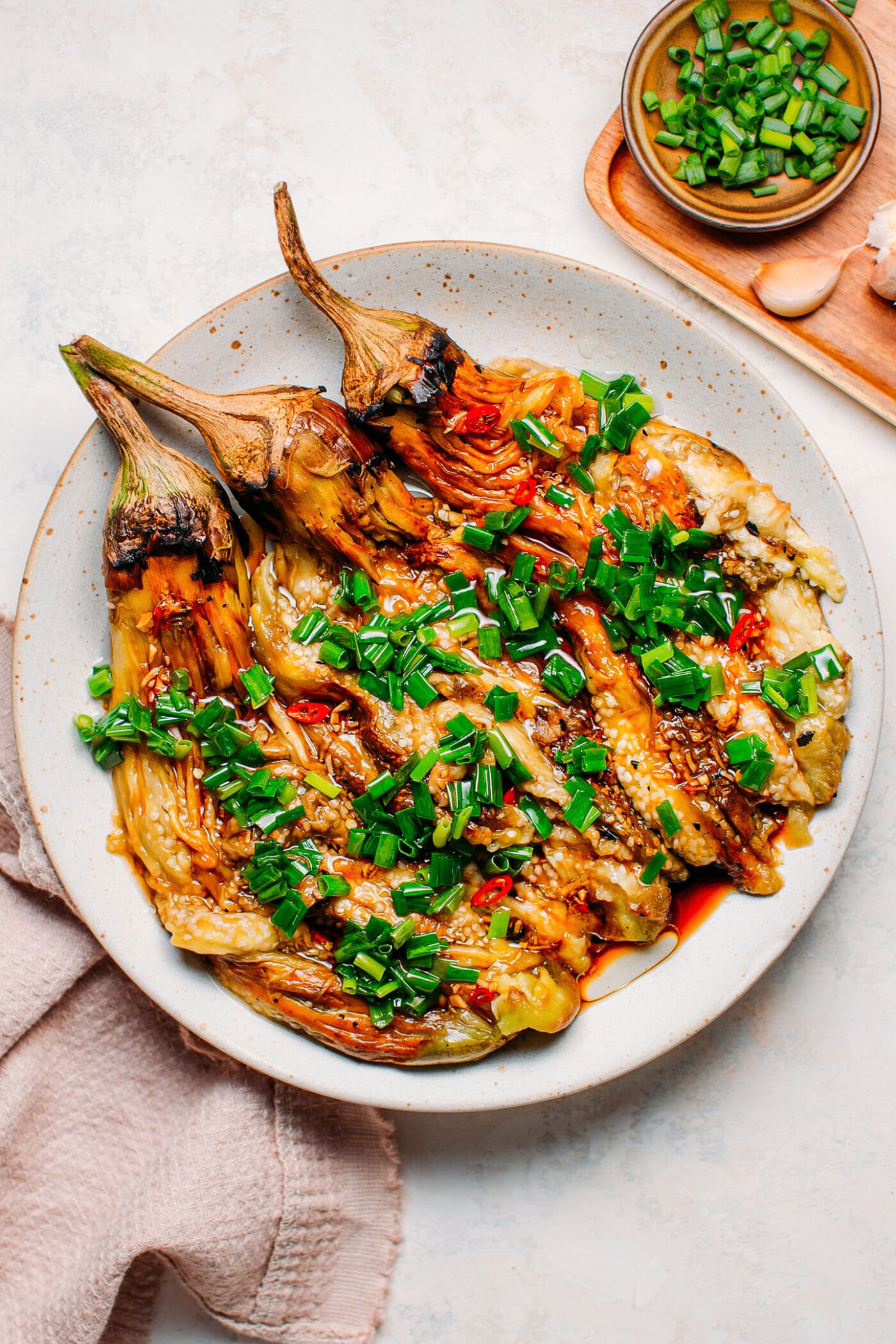 Grilled eggplants topped with green onions and chili.