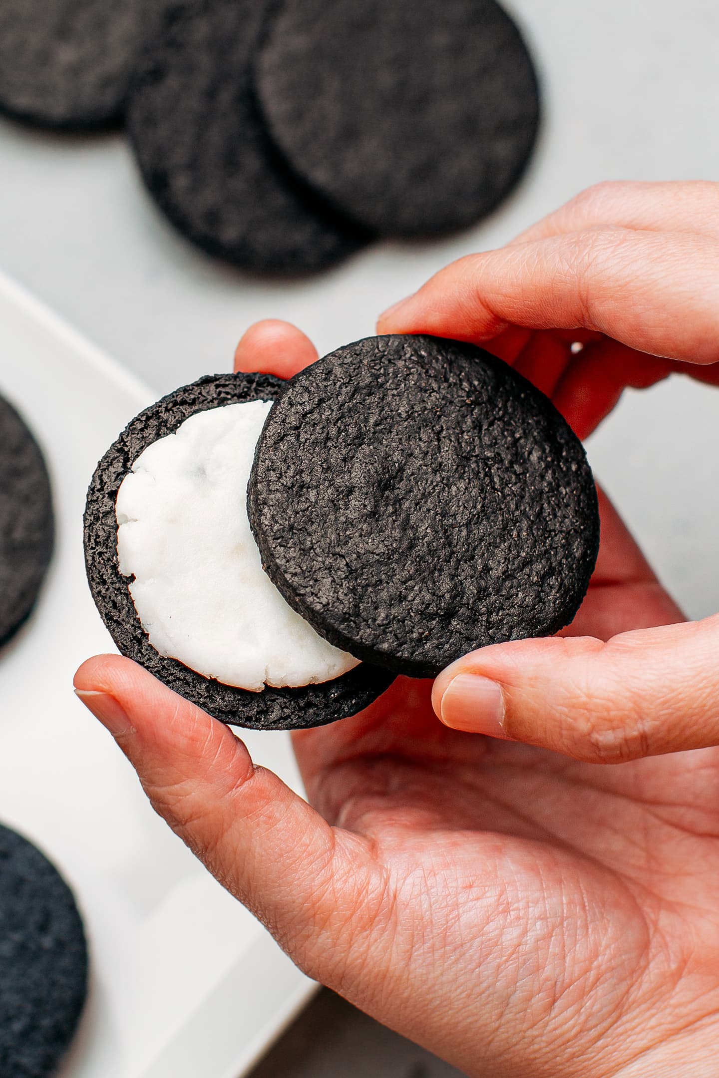 Closing a homemade oreo sandwich cookie.