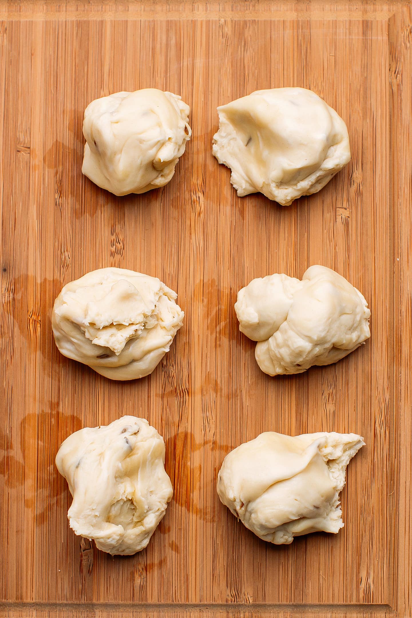Balls of dough on a cutting board.