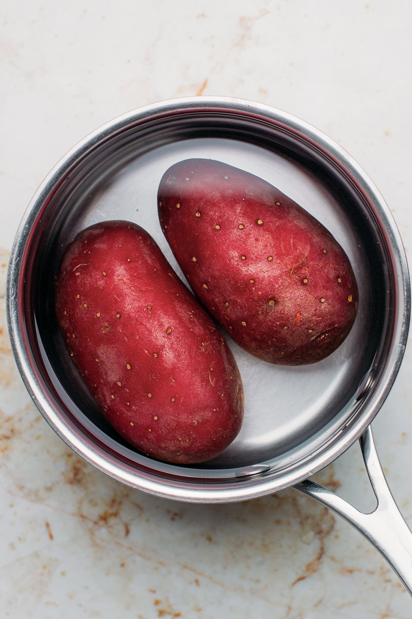 Two potatoes in a pot of water.