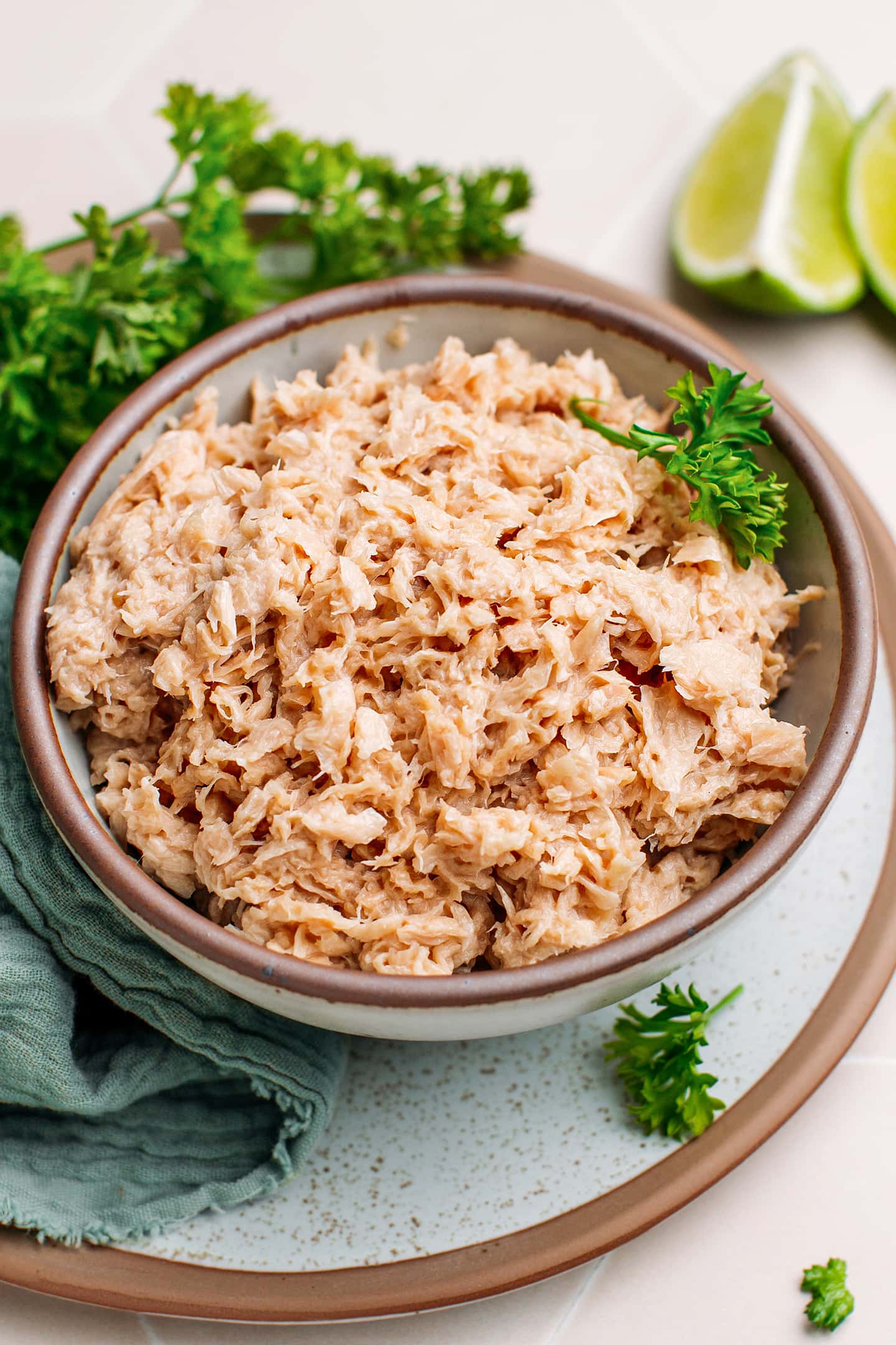 Vegan tuna in a bowl topped with fresh parsley.