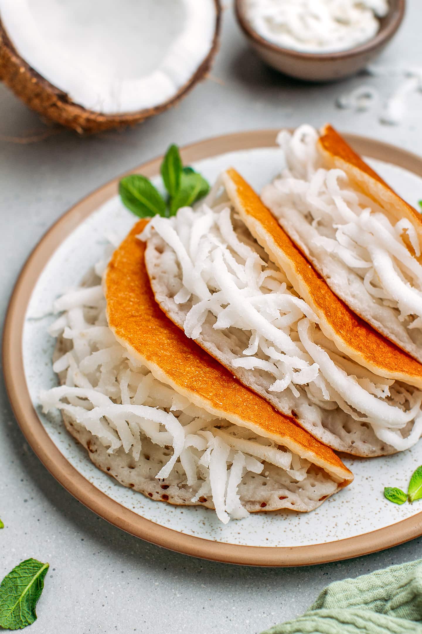 Close-up of coconut pancakes filled with grated coconut.