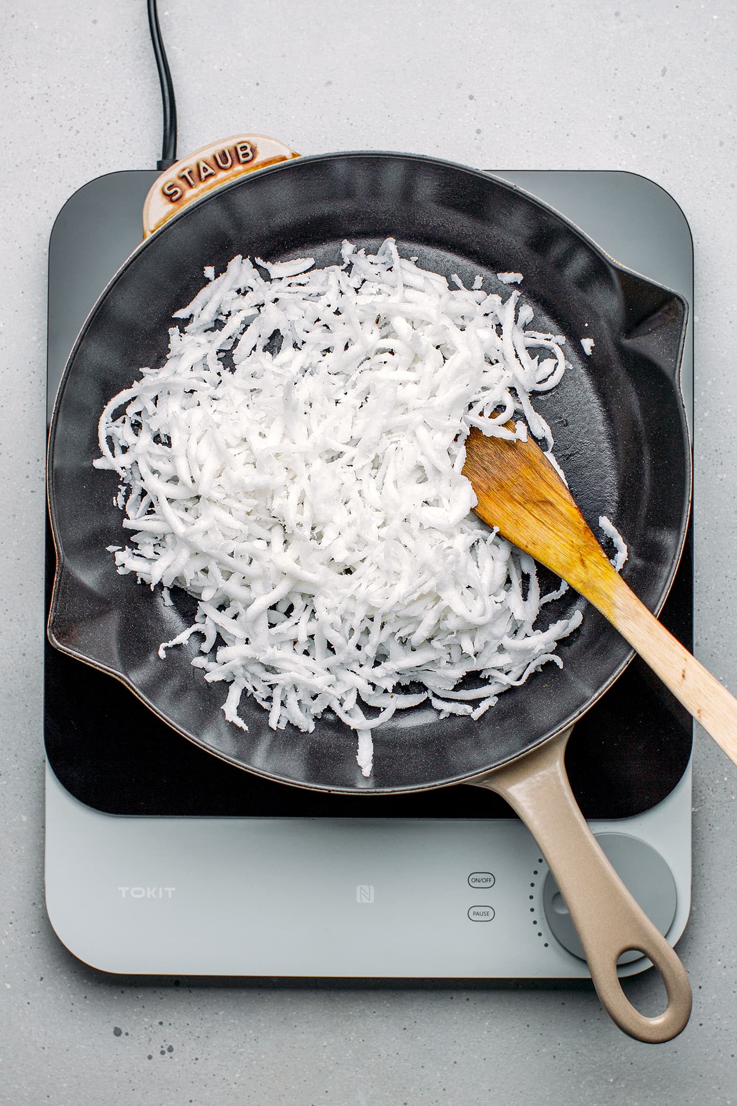 Shredded coconut in a pan.
