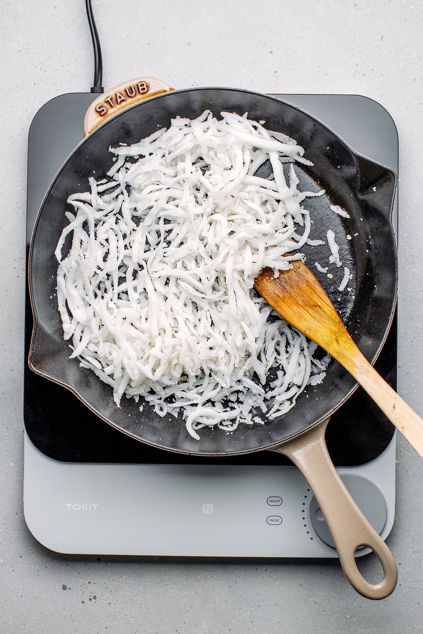 Shredded coconut in a pan.