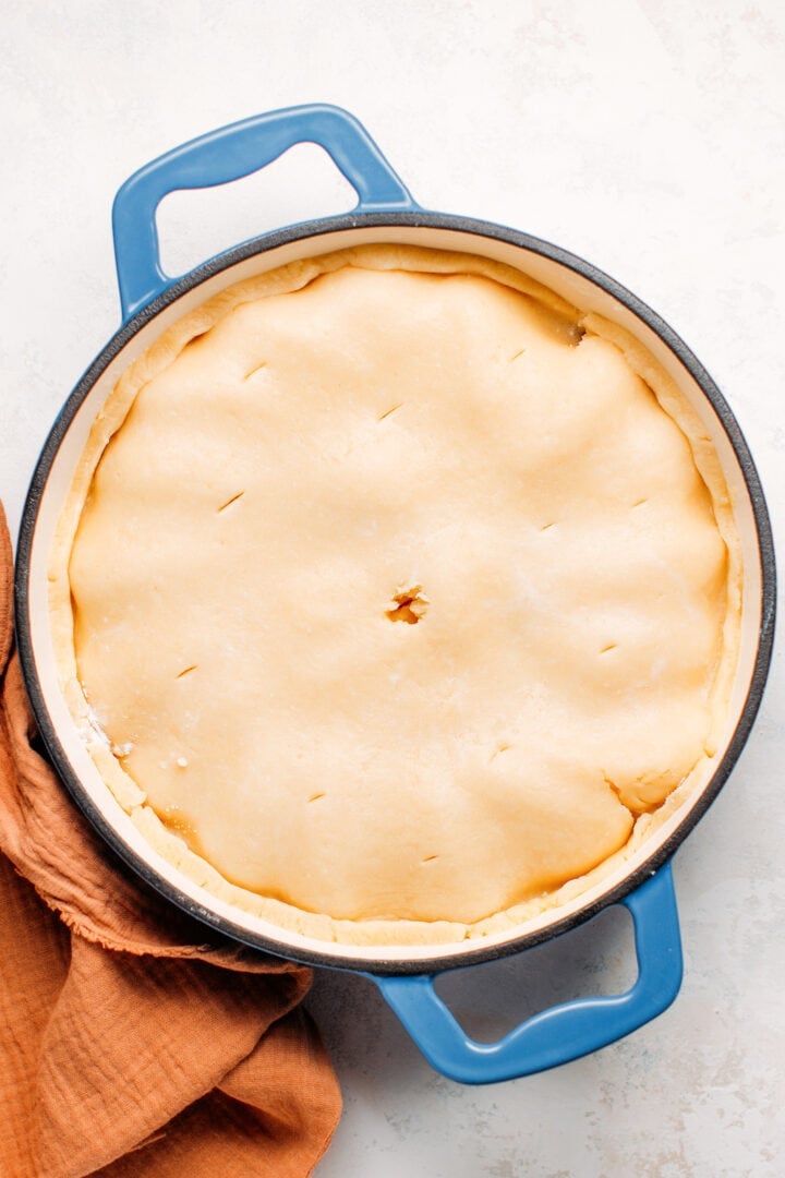 Shortcrust pastry on top of apples, before baking.