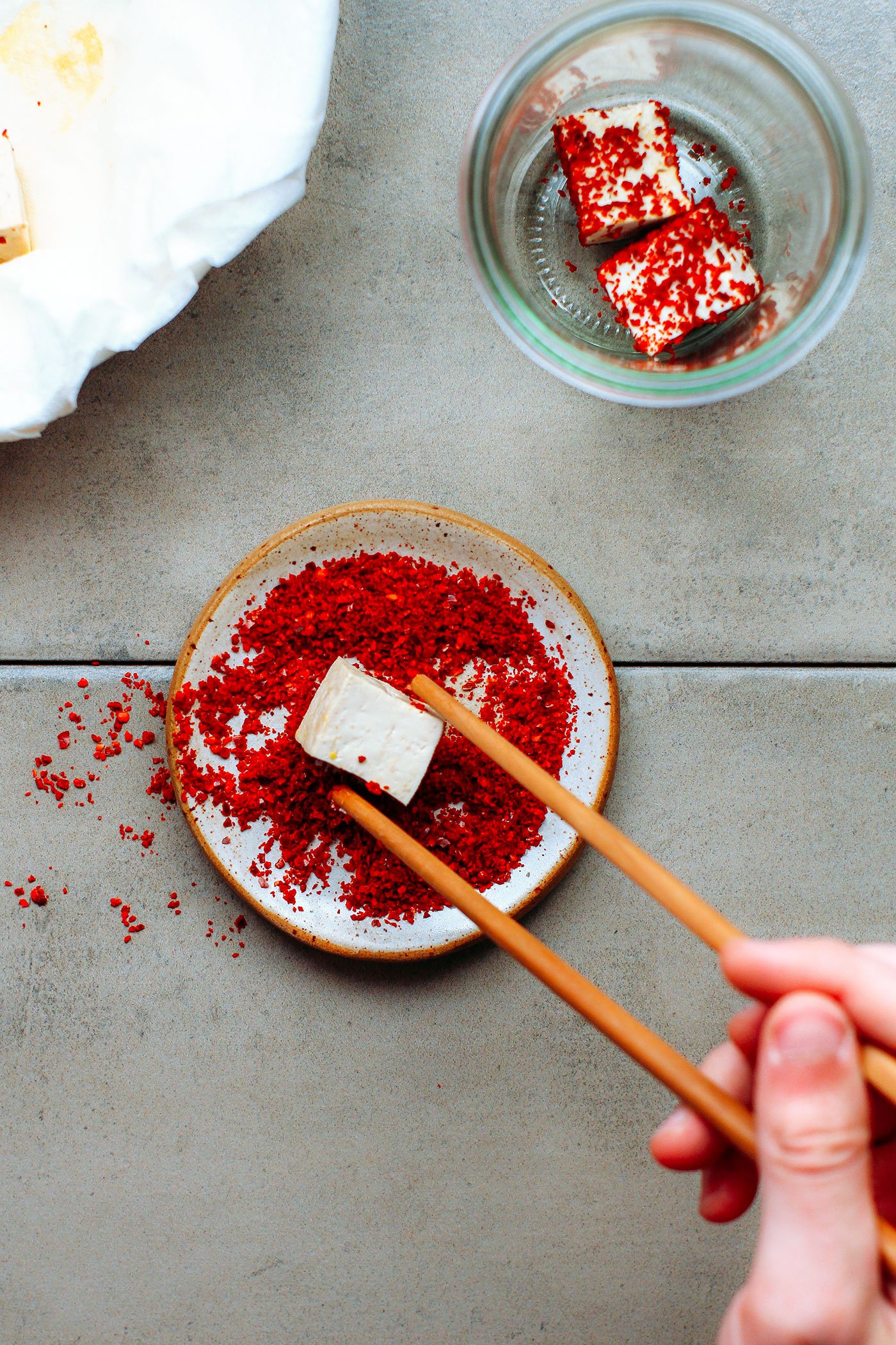 Tofu cube dipped in chili powder to make fermented tofu.