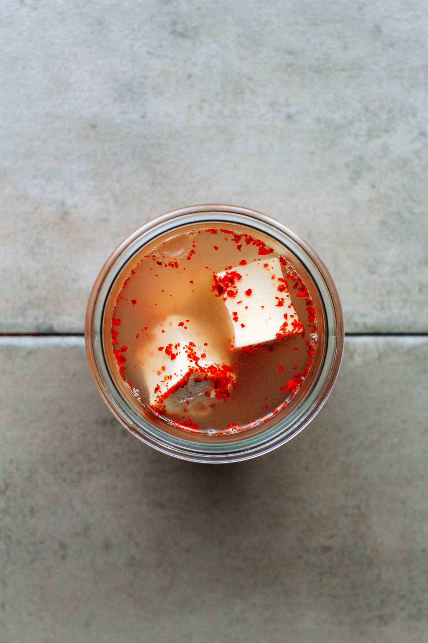 Fermented tofu with chili in a brine.