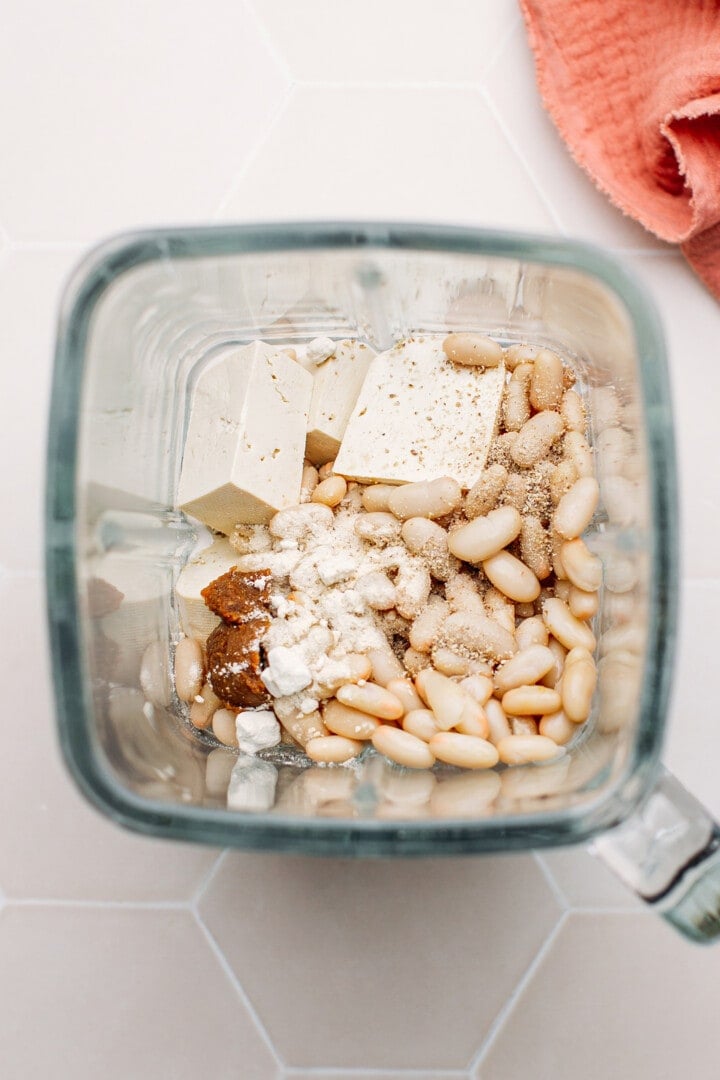 Tofu, white beans, and spices in a blender.